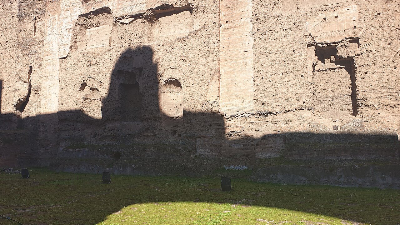 The shadow of a doorway on the high brick wall of the swimming pool at the Baths of Caracalla