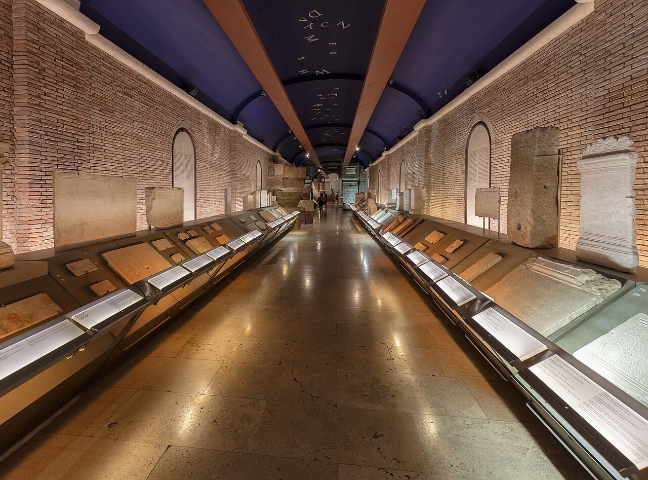 The long vaulted gallery of the Tabularium under the Capitoline, its floor reflecting the lights
