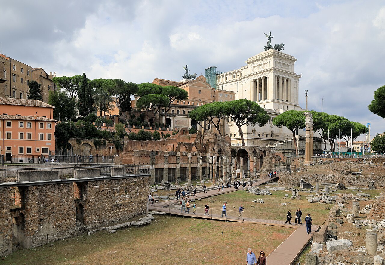 The Forum of Caesar below street level, with the Victor Emmanuel Monument and pines behind