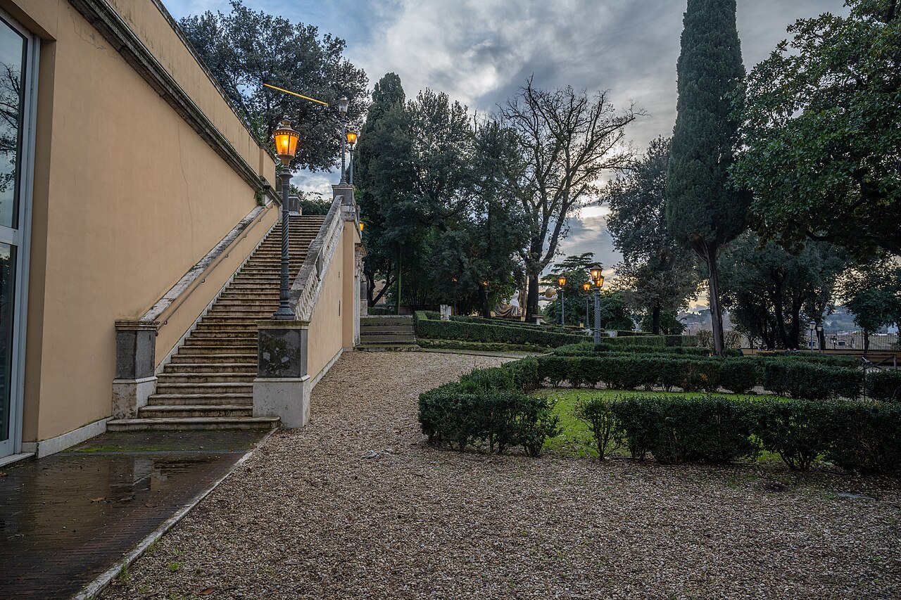 A gravel path and a stone stair in a small garden beside the Capitoline Museums