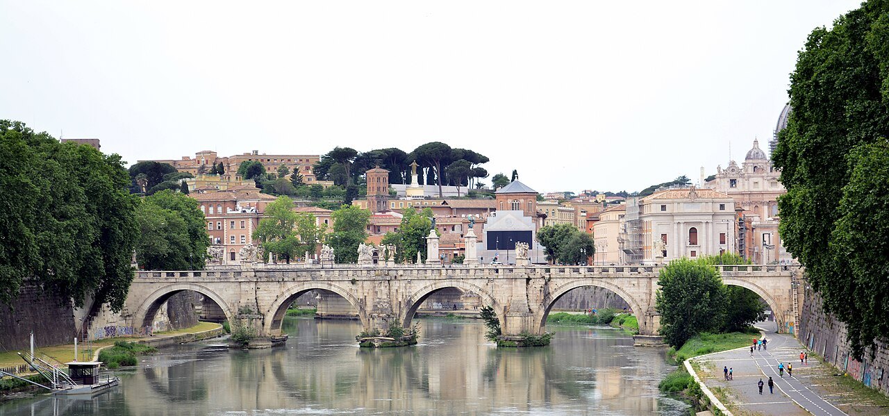 The Ponte Sant'Angelo across the Tiber, with the dome of St. Peter's beyond the rooftops