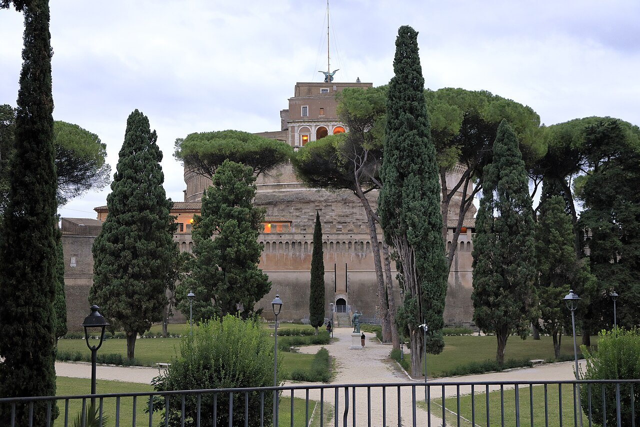 Castel Sant'Angelo seen through cypresses and pines from the gardens around it