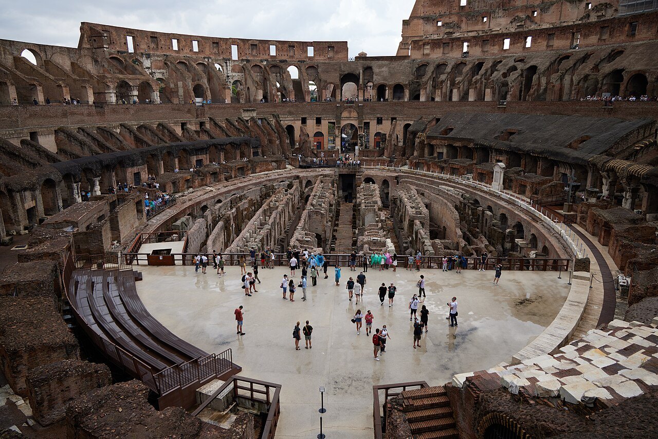 Visitors on the partly rebuilt arena floor of the Colosseum, the seating tiers around