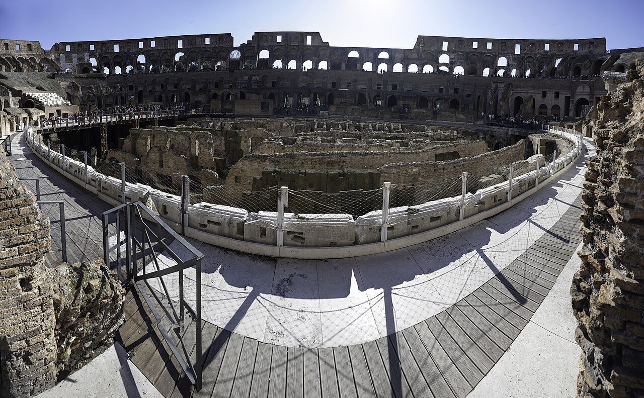 A walkway in the Colosseum above the arena and the brick walls of the underground