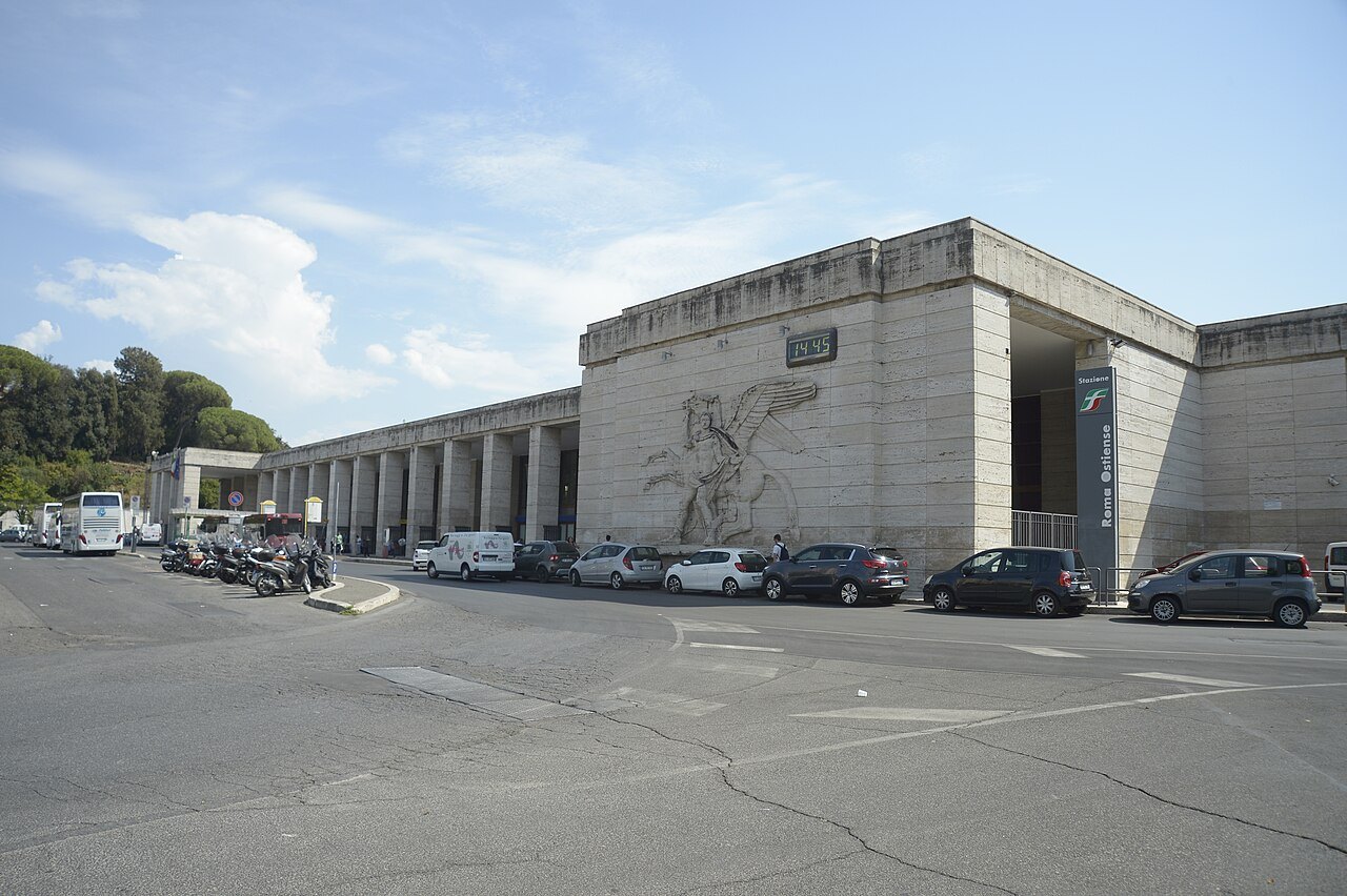 Roma Ostiense station, its long stone portico with a carved relief on the wall
