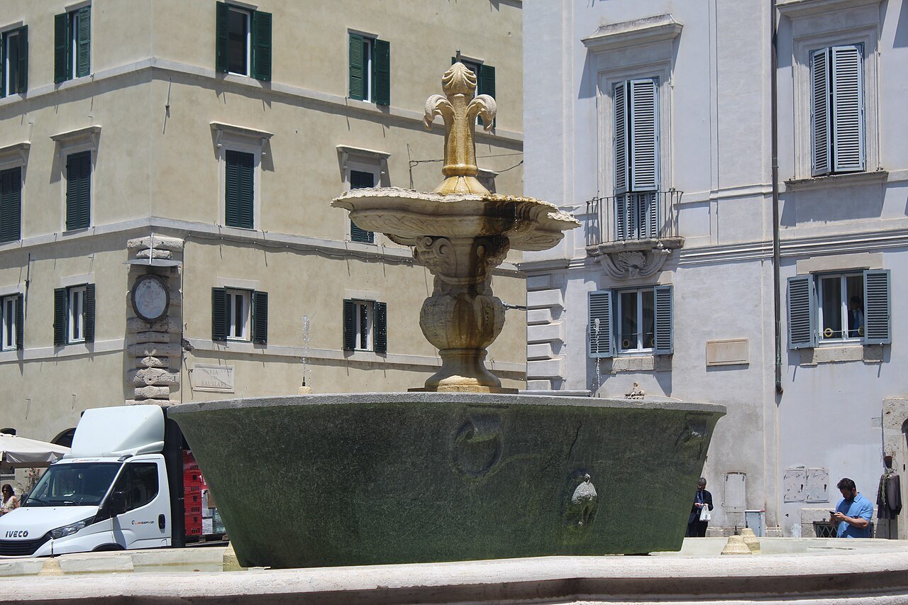 The granite fountain basin in Piazza Farnese, a delivery van parked beside it