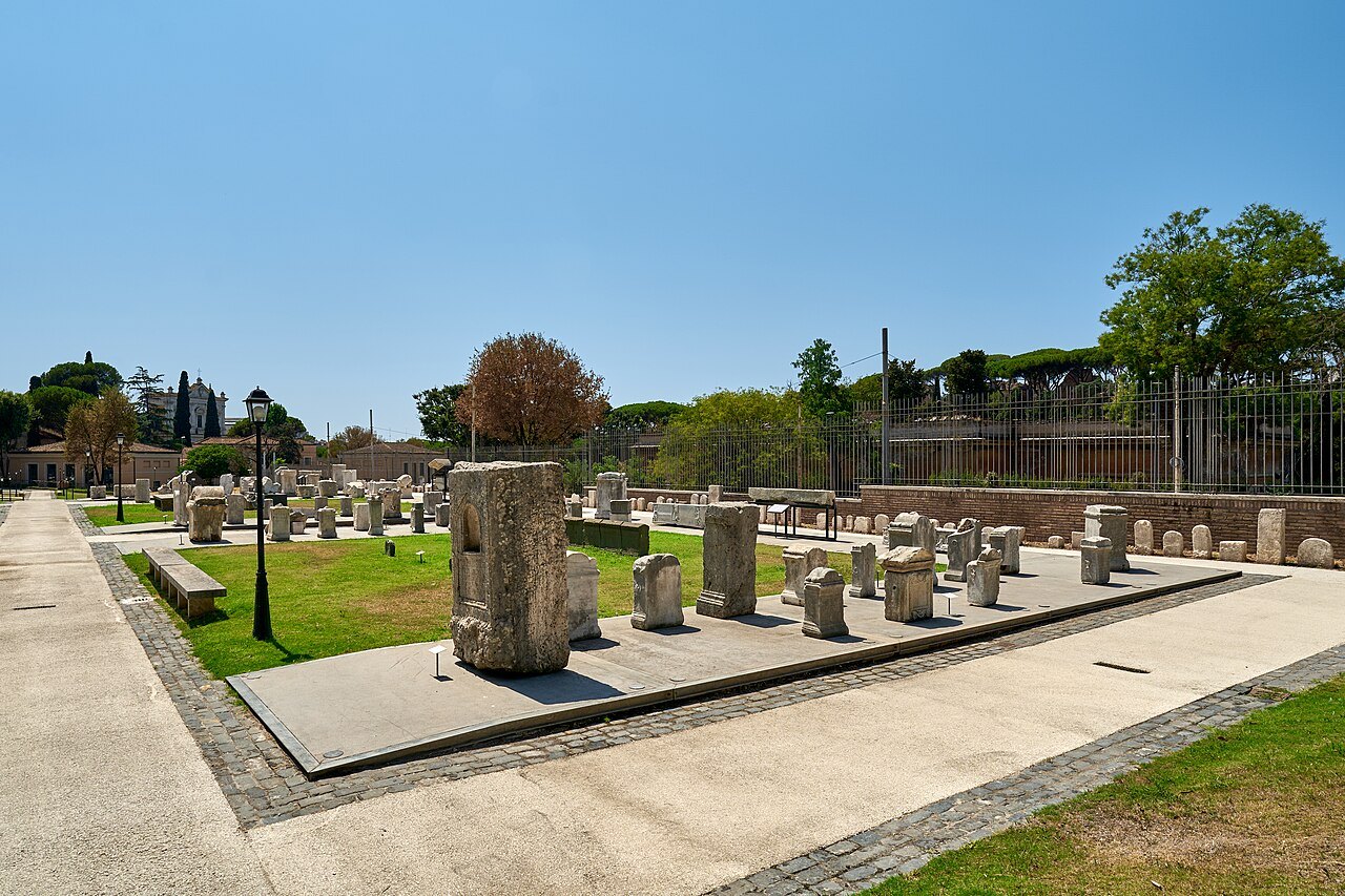 Blocks of ancient stone laid out on a lawn in the Celio archaeological park