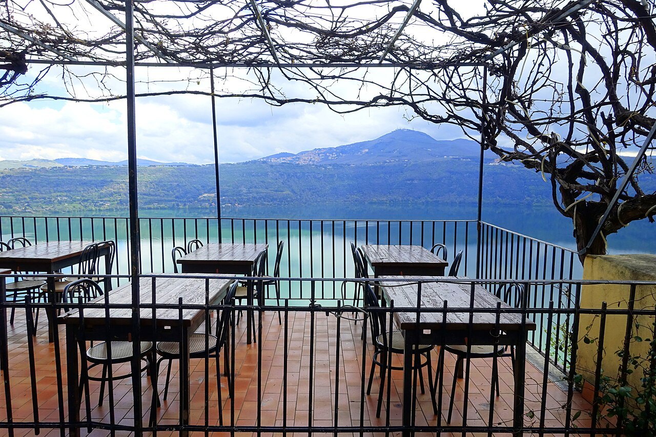 A terrace with tables under a vine in Castel Gandolfo, above Lake Albano