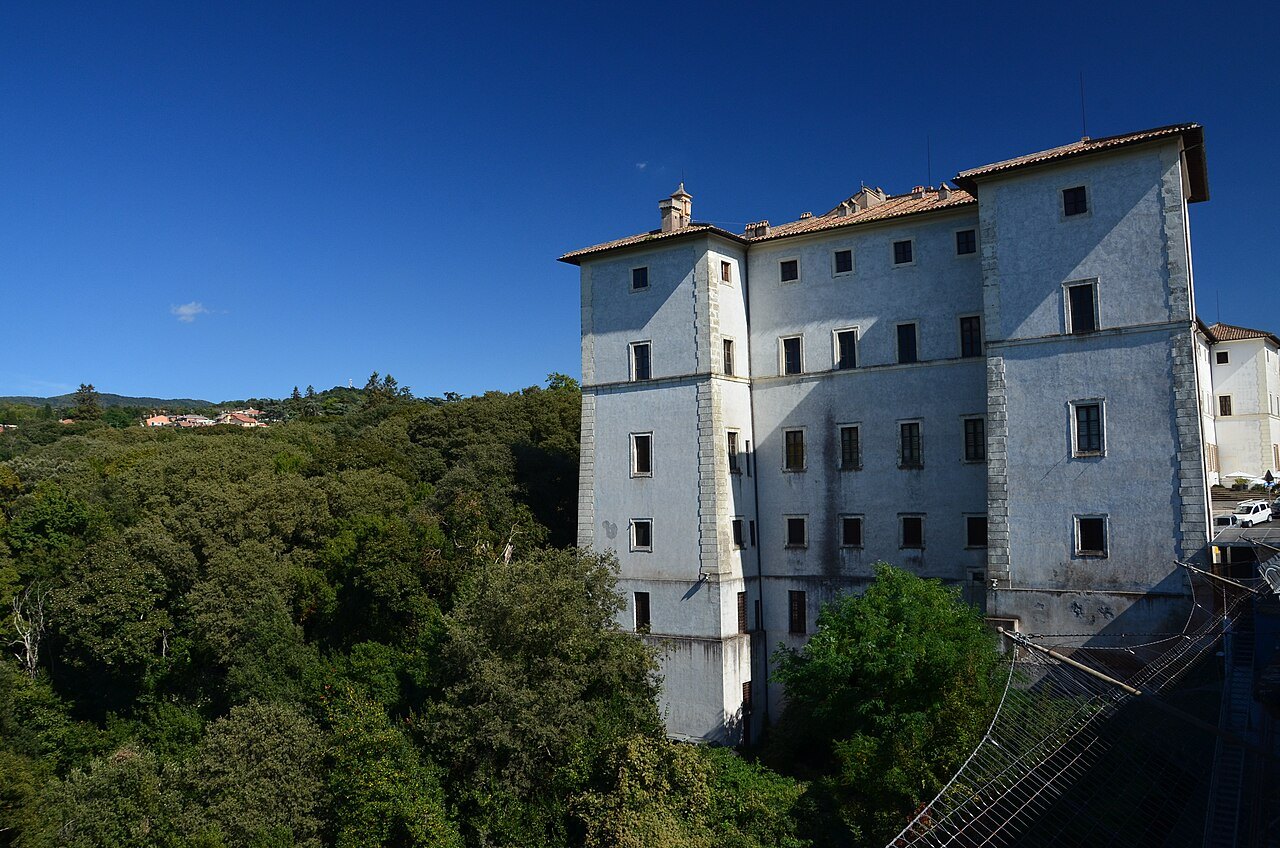 The Palazzo Chigi at Ariccia, white above the woods of the Alban Hills