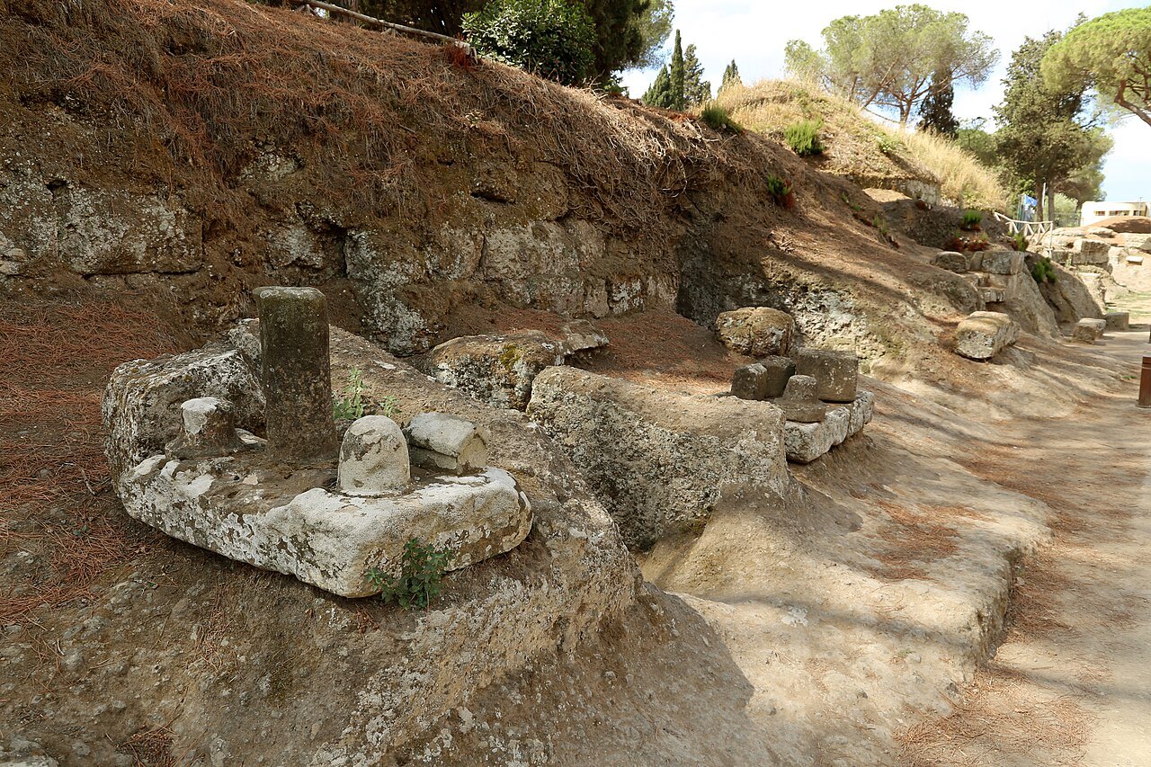 A path through the Banditaccia necropolis at Cerveteri, carved stones and tufa walls