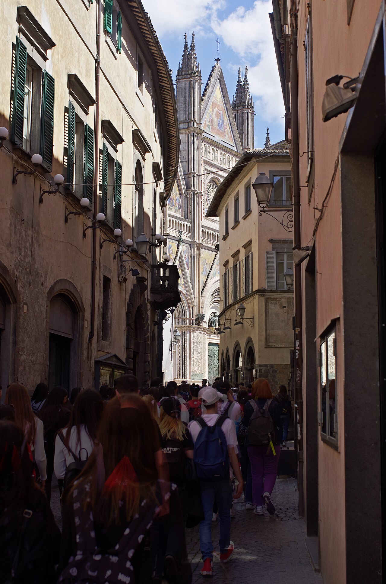 A narrow street in Orvieto leading to the striped side of the cathedral