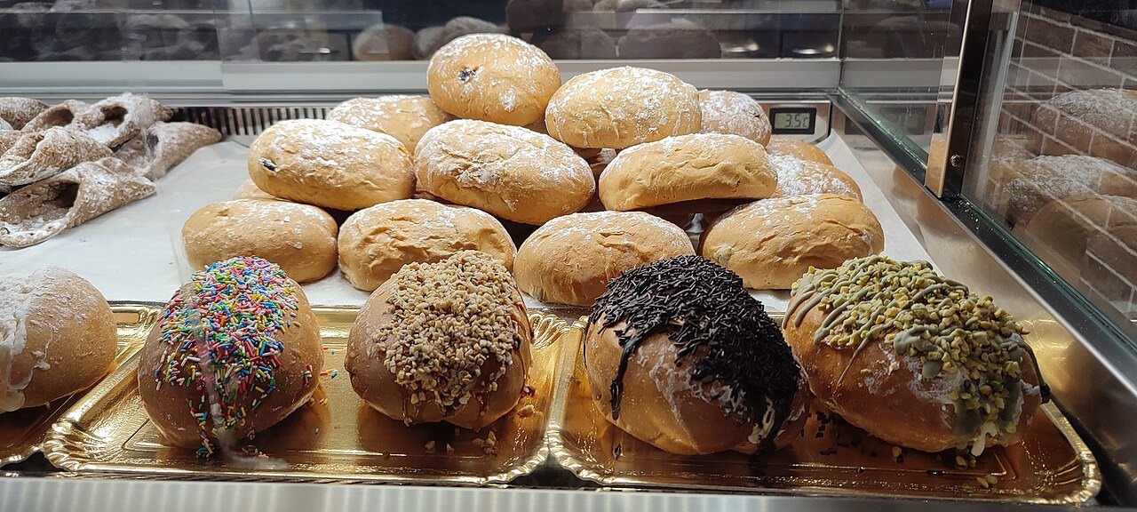 Maritozzi, sweet buns split and filled with cream, in a pastry case