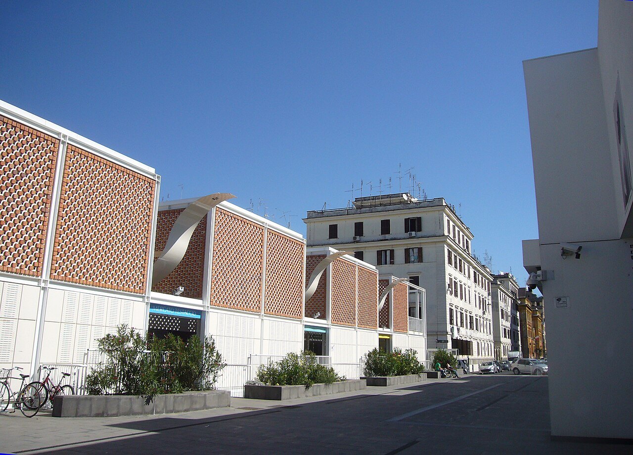 The new market of Testaccio, its brick-latticed walls in a row along the street