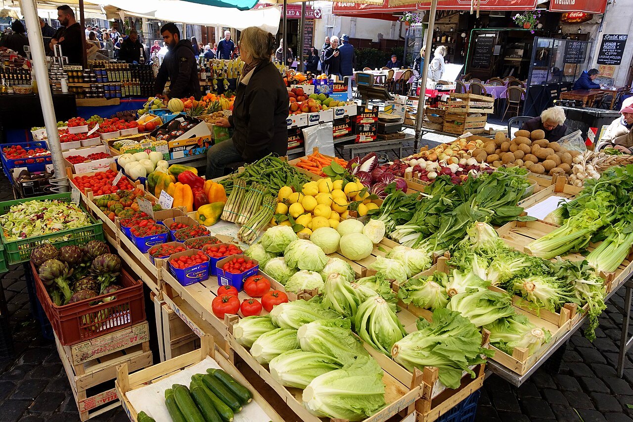 A vegetable stall in Campo de' Fiori heaped with fennel, lettuces, tomatoes and lemons