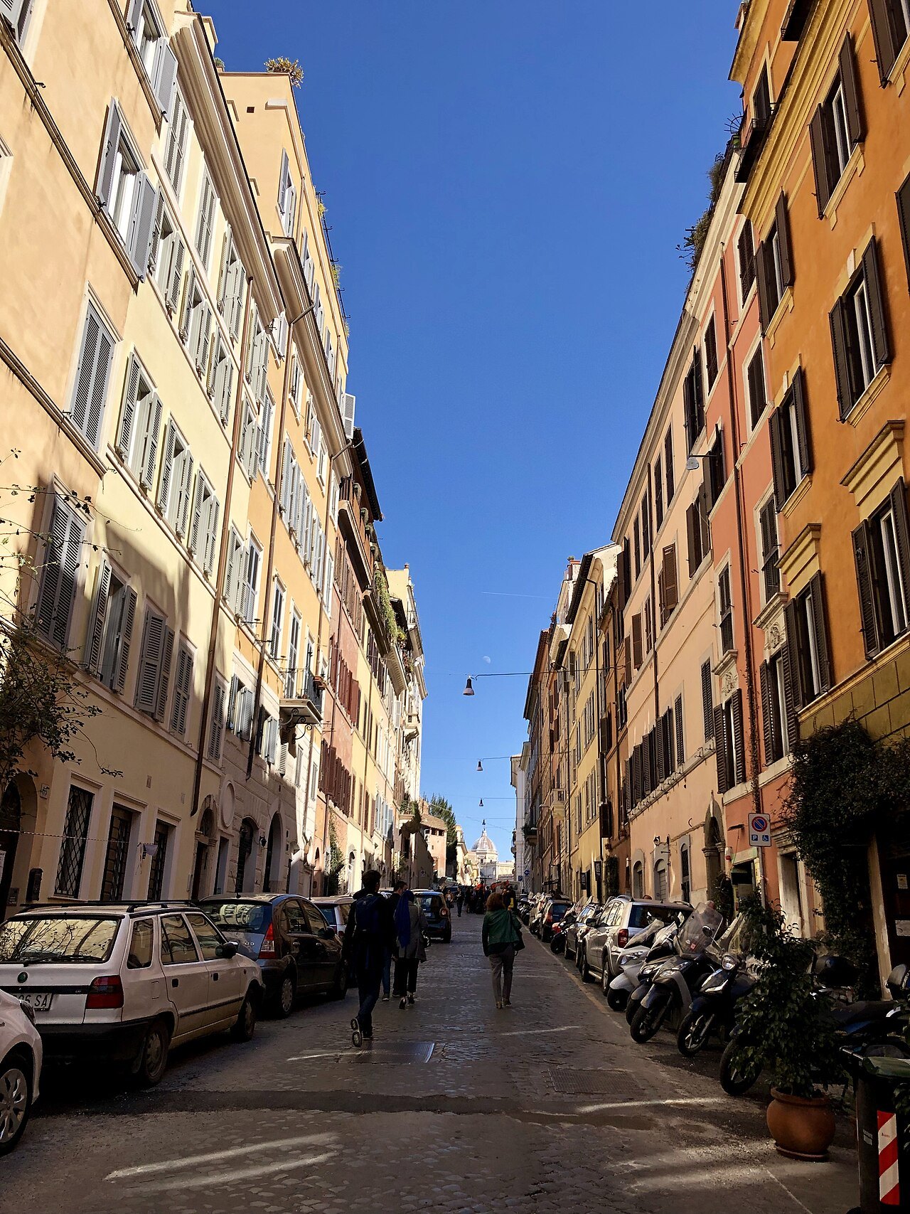 Via Panisperna in Monti, a straight street of ocher houses running downhill