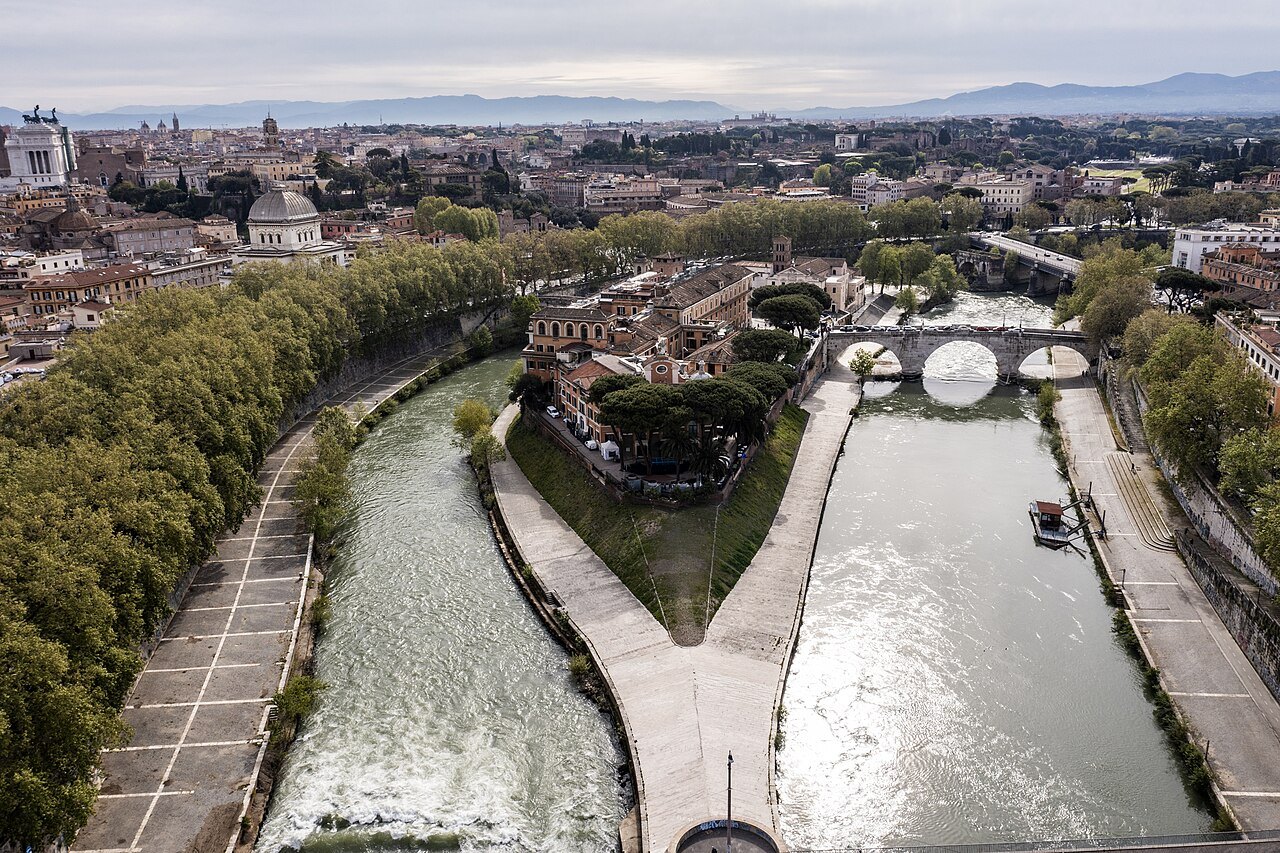 The Tiber Island from above, the river dividing around it and a bridge to each bank