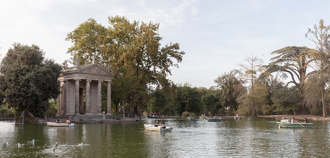 The small temple of Aesculapius on the lake in the Villa Borghese gardens, boats on the water
