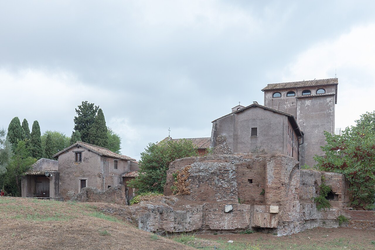 Medieval houses built into the brick ruins on the Palatine, under a gray sky