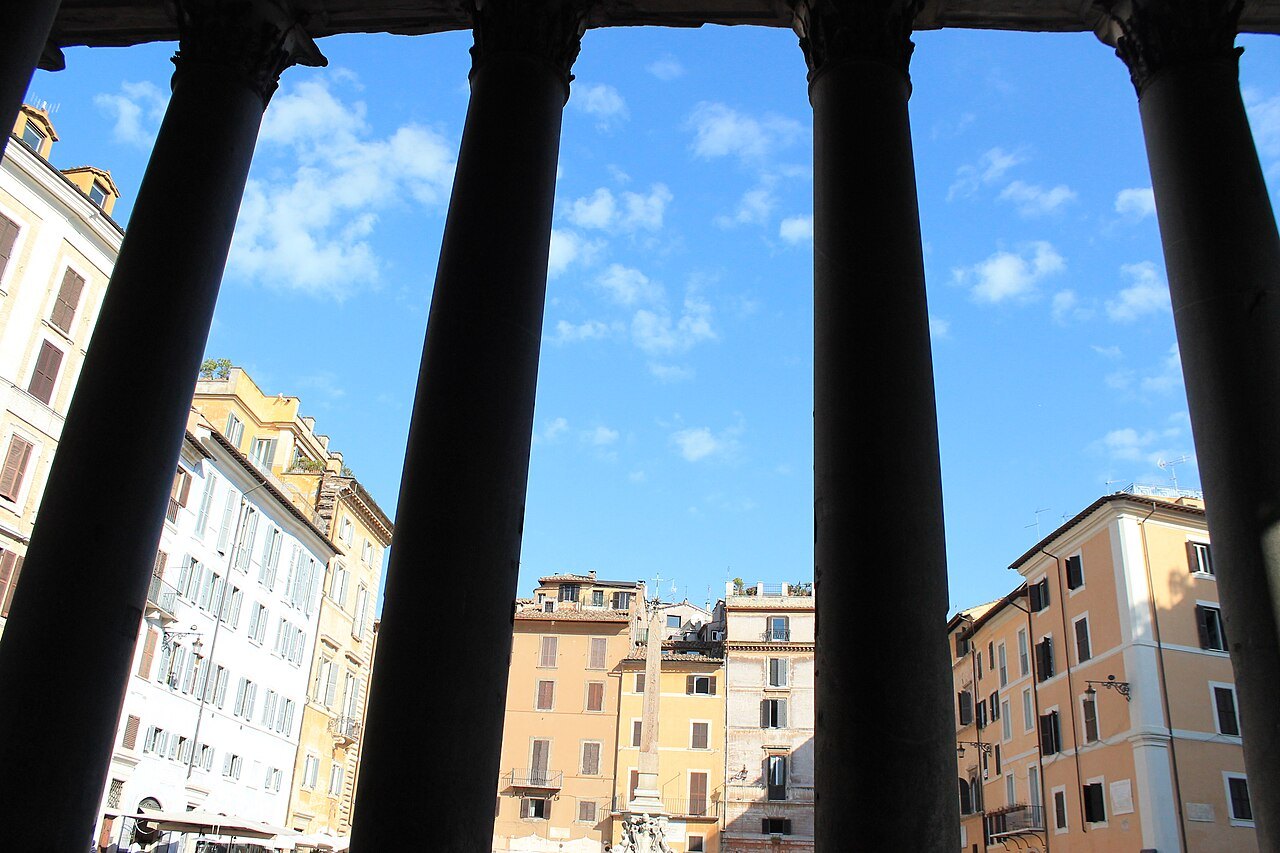 The portico's granite columns framing the ocher houses of Piazza della Rotonda
