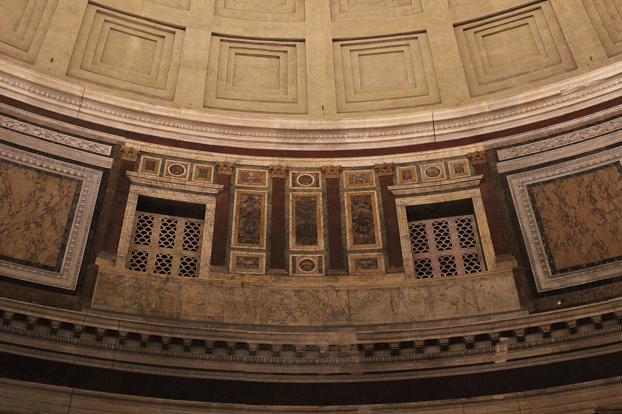 The inner wall of the Pantheon's rotunda, marble panels and grilled niches under the dome
