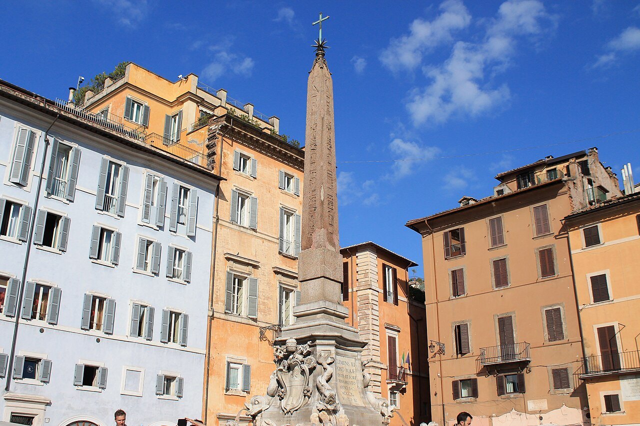 The obelisk on its fountain in Piazza della Rotonda, ocher and pink houses around it