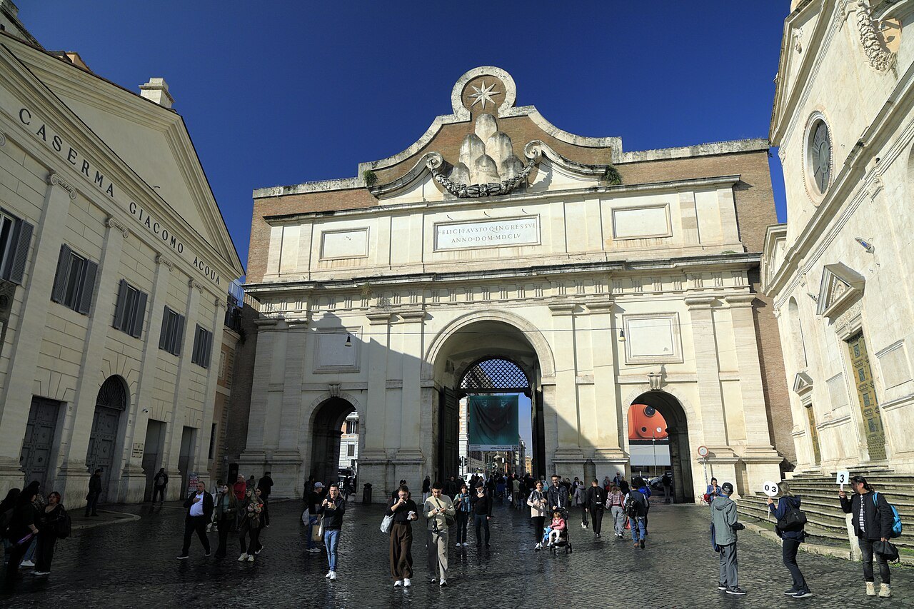 The Porta del Popolo, the old northern gate, with visitors walking through it