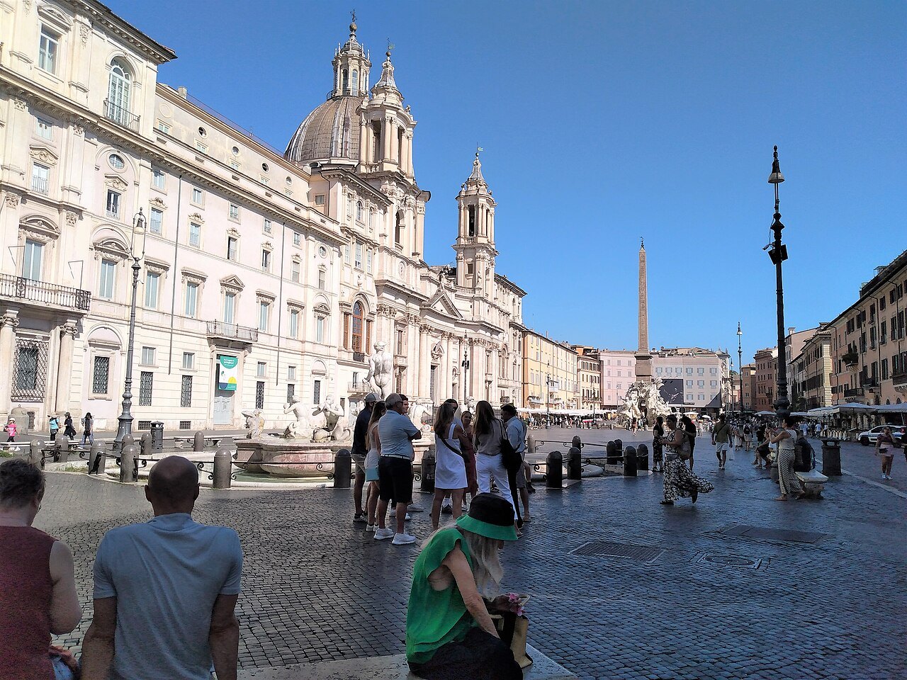 Palazzo Pamphilj and Sant'Agnese on Piazza Navona, visitors on the paving