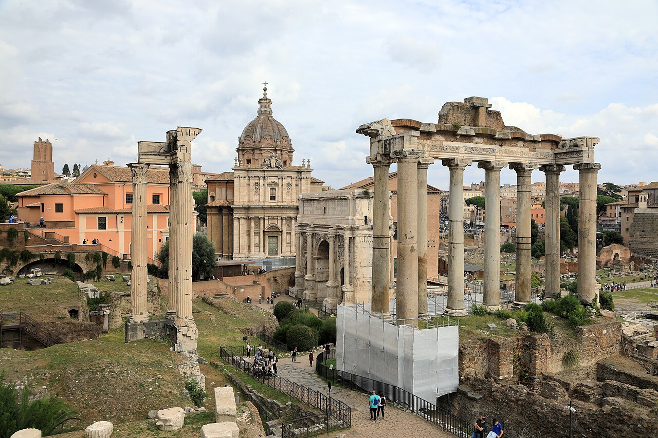 The columns of the Temple of Saturn and the Temple of Vespasian, with a domed church behind