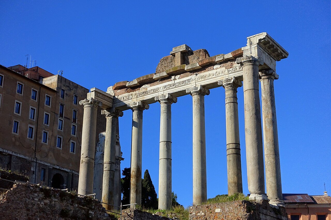 The eight columns of the Temple of Saturn against a deep blue sky