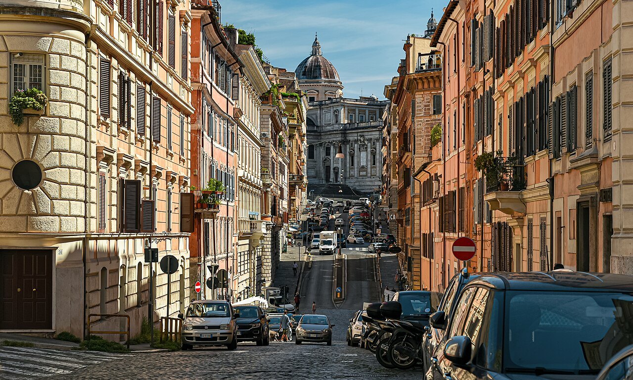A street in Monti rising between old houses to the dome of Santa Maria Maggiore
