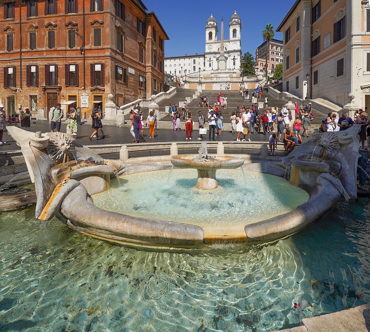 The Barcaccia fountain at the foot of the Spanish Steps, the stair and the church above
