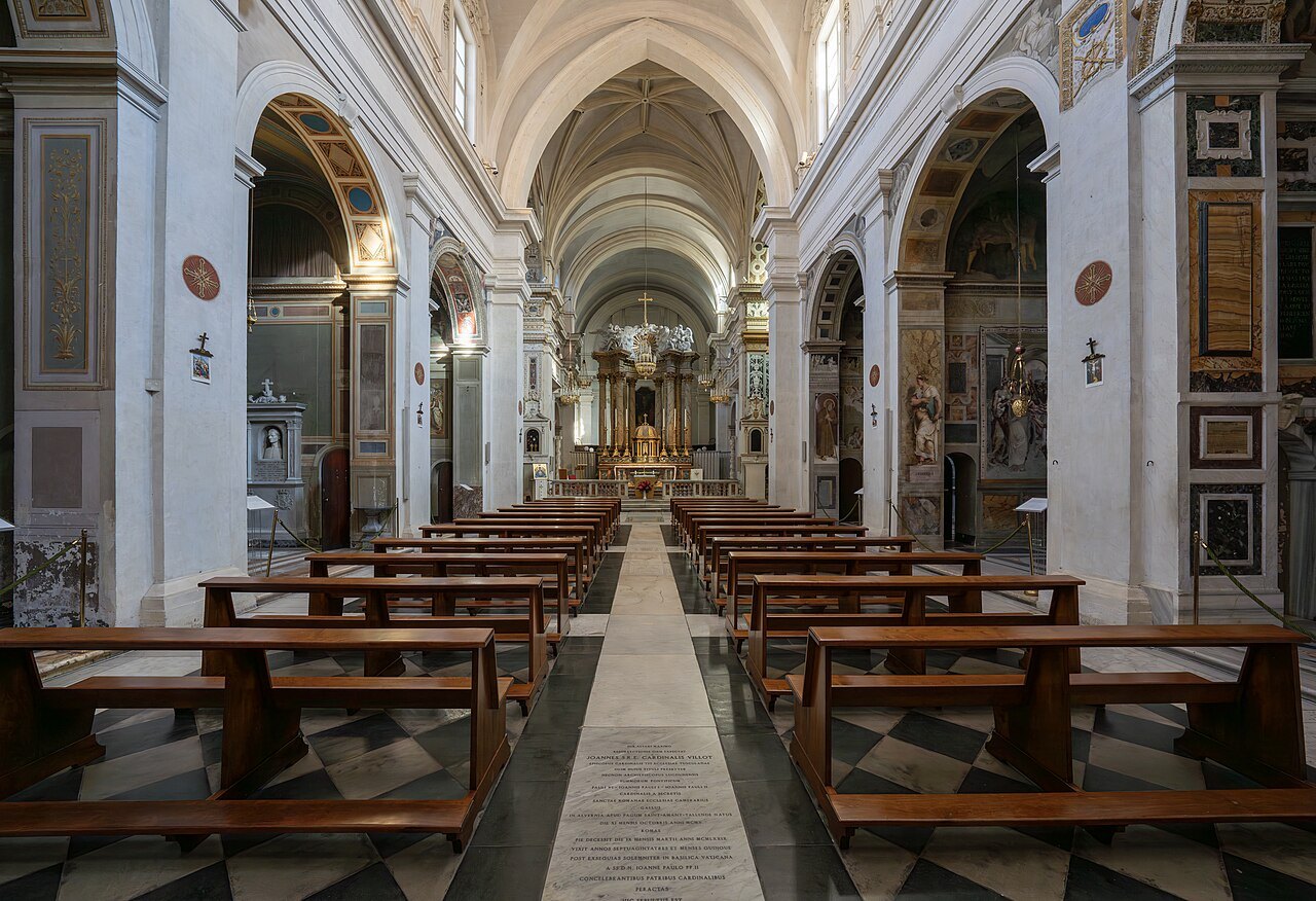 The nave of Trinità dei Monti, pews leading to the altar under a pale vault