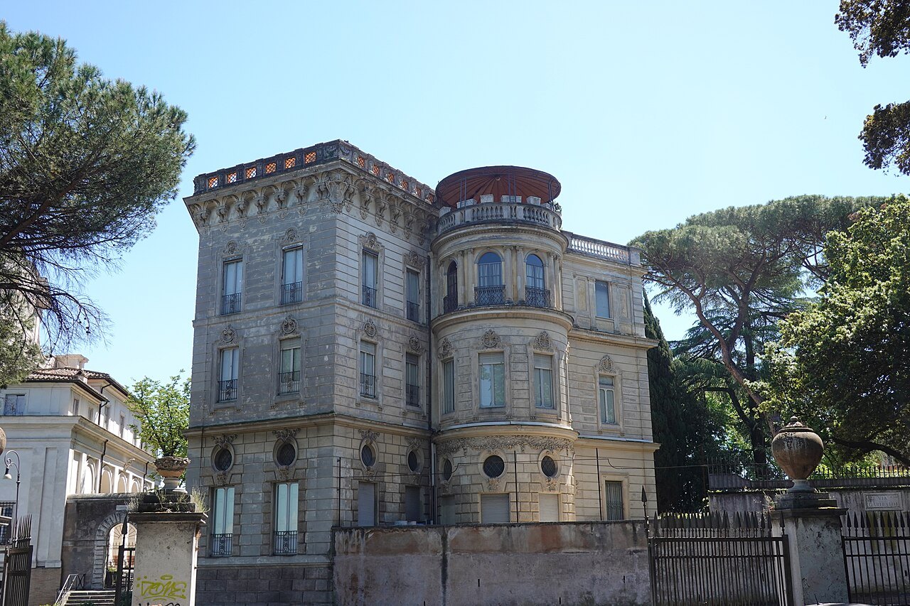 A turreted villa on Via Garibaldi on the Janiculum, umbrella pines beside it