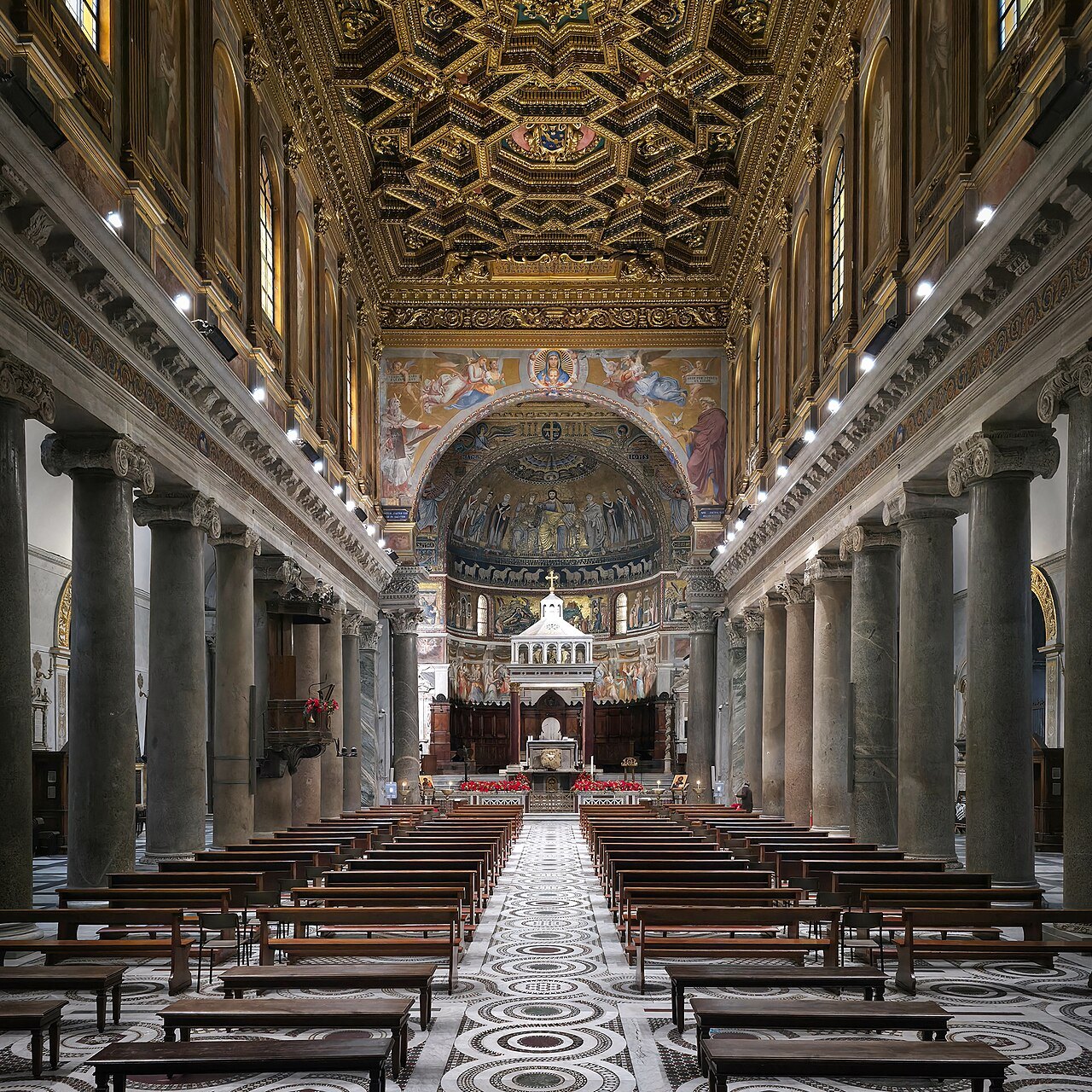The nave of Santa Maria in Trastevere, granite columns leading to the apse mosaics