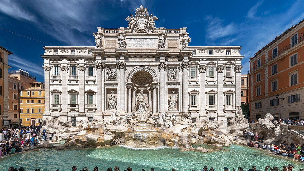 The Trevi Fountain and its crowded basin in full sun, with the palace façade behind